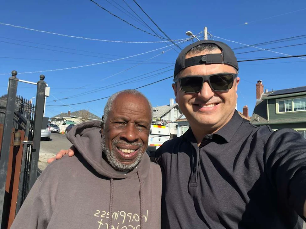 Happy couple standing in front of their house