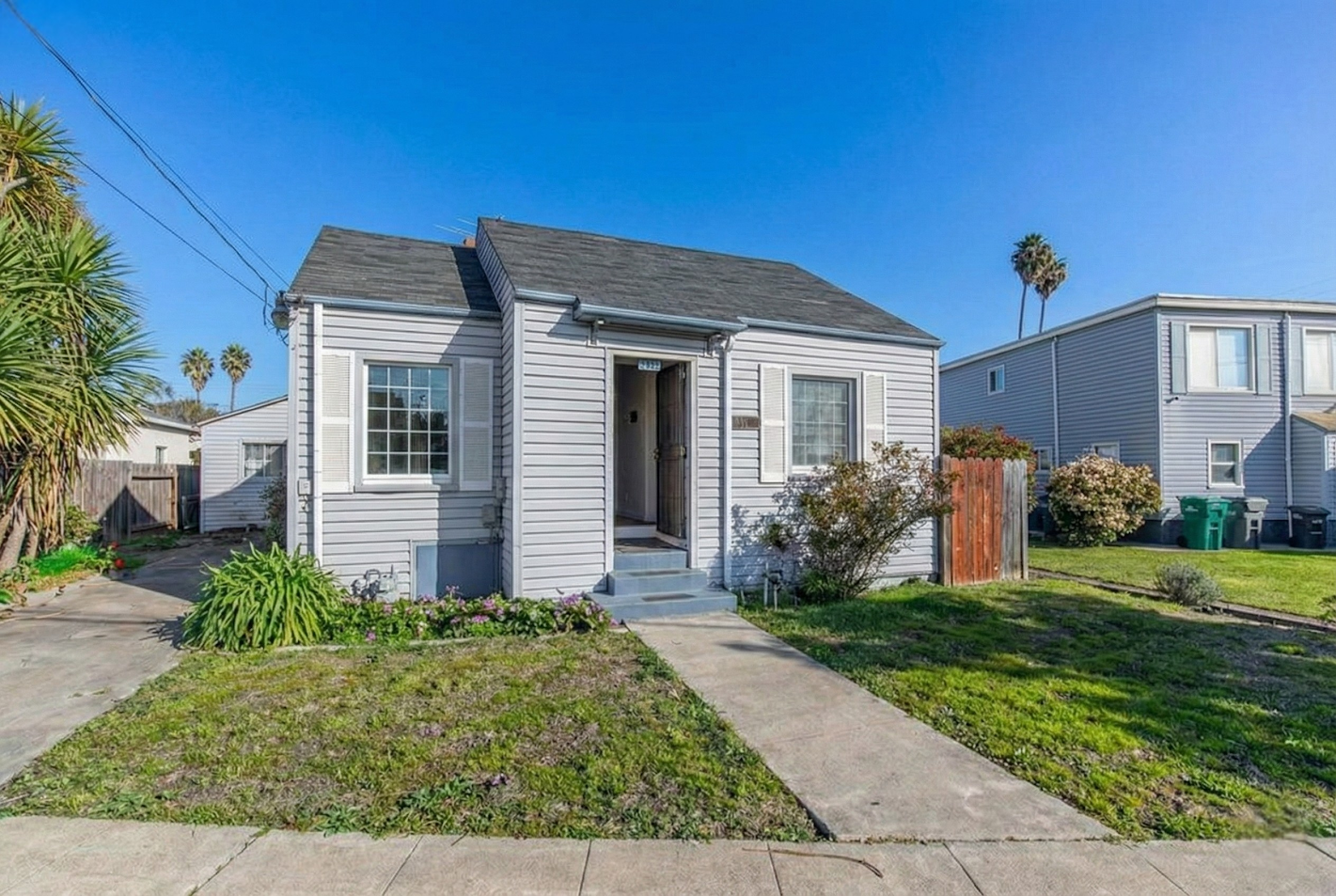 Happy seller standing in front of house