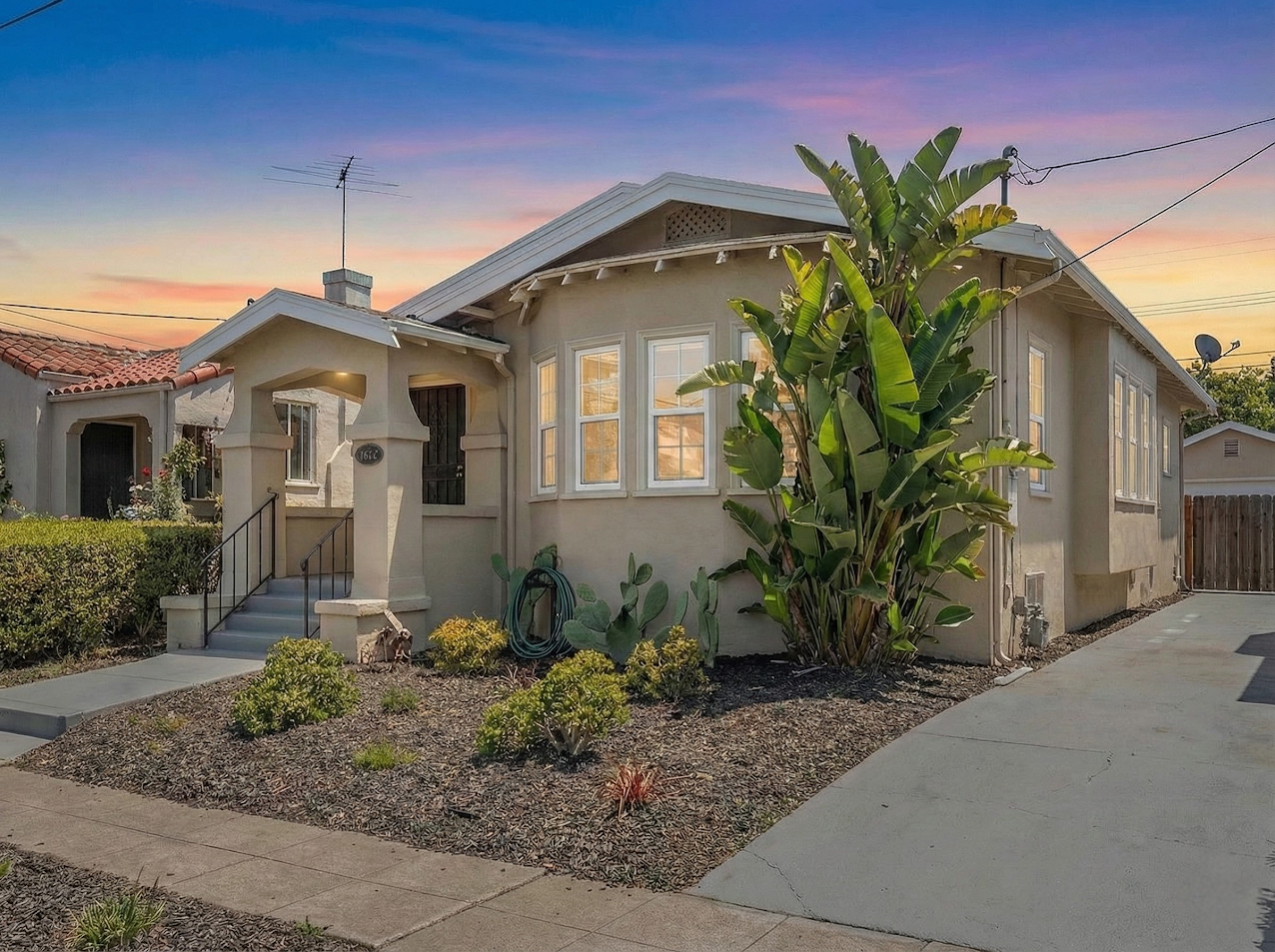 Happy couple standing in front of their house